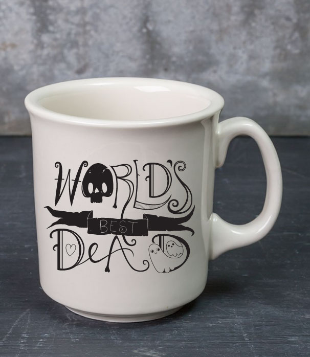White mug that says "World's Best Dead" in spooky hand lettering.